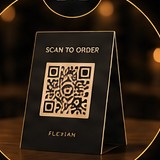 A Flexian “Scan to order” QR menu card on a table.