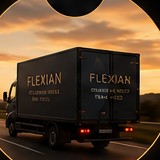 A Flexian delivery truck on the road at sunset.