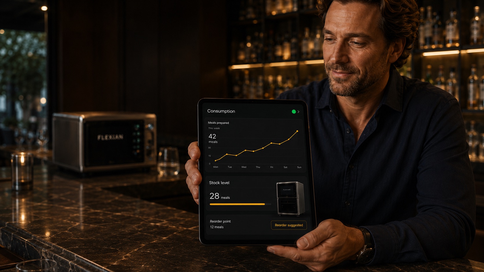 A hospitality owner reviews the Flexian consumption and stock dashboard on a tablet.
